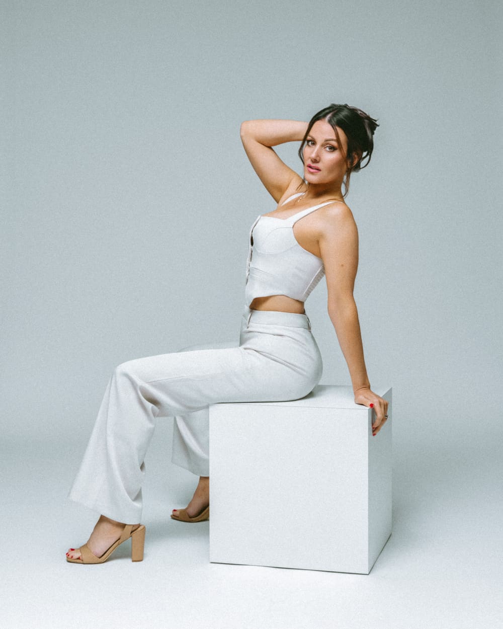 Three-quarter seated commercial pose in white