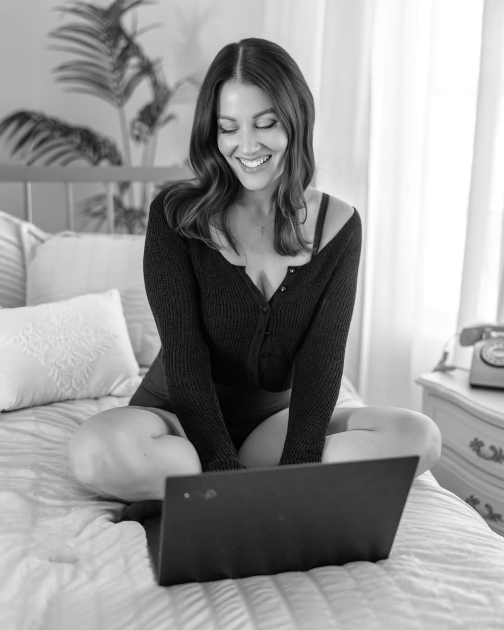 Black-and-white lifestyle shot working on a laptop